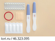 Different contraceptives and pregnancy tests on color background. Стоковое фото, фотограф Pixel_shot / Фотобанк Лори