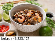 Bowl with tasty soba noodles and seafood on light background. Стоковое фото, фотограф Pixel_shot / Фотобанк Лори