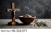 Religion, faith, liturgy, Ash Wednesday. Great lent. A wooden cross, a ceremonial bowl made of ash and an olive branch on a gray background. Стоковое AI-изображение, AI-художник Photojuli / Фотобанк Лори