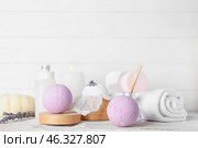 Beautiful spa composition with lavender bath bombs and burning candles on light wooden background. Стоковое фото, фотограф Pixel_shot / Фотобанк Лори