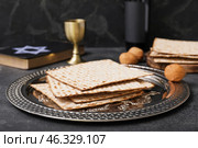 Passover Seder plate with matzo on dark background. Стоковое фото, фотограф Pixel_shot / Фотобанк Лори
