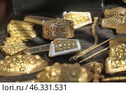 Gold and gilded jewelry and items made in the style of ancient Russian or Scandinavian craft traditions. Among them you can see buckles, bracelets, clasps, decorative elements, brooches and hairpins. All items are richly decorated with patterns, carvings and inlays. Some elements are made using enamel and silver inserts, creating an impressive composition of jewelry art.The presented artifacts are probably reconstructions of ancient finds or items from a historical festival dedicated to the Viking Age, Slavs or nomadic peoples of Eurasia. They could be used as jewelry or signs of social status. Стоковое фото, фотограф Анна Кривицкая / Фотобанк Лори
