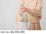 Woman with eco bag on light background. Стоковое фото, фотограф Pixel_shot / Фотобанк Лори