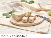 Board with tasty tofu cheese on table. Стоковое фото, фотограф Pixel_shot / Фотобанк Лори