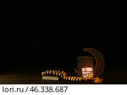 Arabic candle holder with glowing candle, Quran and tasbih on dark background. Стоковое фото, фотограф Pixel_shot / Фотобанк Лори