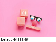 Composition with party decor and cube calendar with date 1 APRIL on color background. April Fools Day celebration. Стоковое фото, фотограф Pixel_shot / Фотобанк Лори