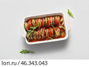 Baking dish of tasty Ratatouille on white background. Стоковое фото, фотограф Pixel_shot / Фотобанк Лори