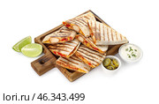 Board with tasty quesadillas, lime, sauce and pickled jalapenos on white background. Стоковое фото, фотограф Pixel_shot / Фотобанк Лори