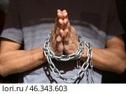 Male hostage with tied hands praying, closeup. Стоковое фото, фотограф Pixel_shot / Фотобанк Лори