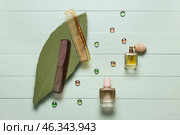 Composition with hair combs and bottles of perfume on color wooden background. Стоковое фото, фотограф Pixel_shot / Фотобанк Лори