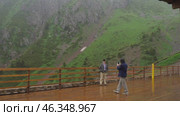 Tourists in the Medeo mountains on a rainy cool day (2024 год). Редакционное видео, видеограф Игорь Жоров / Фотобанк Лори