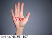 Female palm with word STOP on grey background. Corruption concept. Стоковое фото, фотограф Pixel_shot / Фотобанк Лори