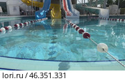 Colorful slides in water park on sunny day (2024 год). Стоковое видео, видеограф Ирина Старикова / Фотобанк Лори