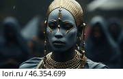 A mysterious woman with dark blue skin adorned with gold elements that give her an otherworldly or mythological appearance. She wears a massive gold headdress reminiscent of traditional royal or ritual jewelry. Her face is hidden in shadow and her gaze is directed straight ahead, creating a powerful presence. She wears massive beaded necklaces around her neck, and earrings, bracelets, and a mask complete the look. The background is blurred, with hooded figures, creating the atmosphere of a secret ritual or royal ceremony. Стоковое AI-изображение, AI-художник Анна Кривицкая / Фотобанк Лори