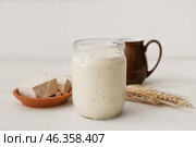 Jar with sourdough on white wooden background. Стоковое фото, фотограф Pixel_shot / Фотобанк Лори