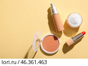 Liquid foundation, powder, lipstick and concealer on color background. Стоковое фото, фотограф Pixel_shot / Фотобанк Лори