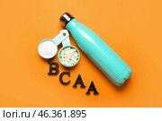 Letters BCAA, amino acid pills, powder and bottle of water on color background. Стоковое фото, фотограф Pixel_shot / Фотобанк Лори