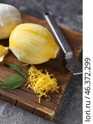Peeled ripe lemon with zest on wooden board. Стоковое фото, фотограф Pixel_shot / Фотобанк Лори