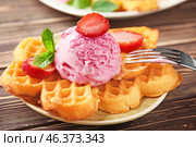 Delicious waffles with ice cream and strawberry on plate. Стоковое фото, фотограф Pixel_shot / Фотобанк Лори