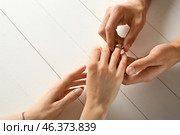 Young man putting engagement ring on fiancee's finger, closeup. Стоковое фото, фотограф Pixel_shot / Фотобанк Лори