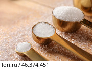 Spoons with refined sugar on wooden background. Стоковое фото, фотограф Pixel_shot / Фотобанк Лори