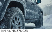 Icy car. Wheel skids in the snow. Frozen Auto. Ice covered Vehicle during Snowstorm. Hazardous Winter Road Driving. Cold Season. Corrosion, Rust. Close-up of tires. Trail of tread marks in thick snow. Стоковое AI-видео, аниматор Марина Демидюк / Фотобанк Лори