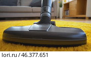 Cleaning orange carpet with vacuum cleaner at home. Living space. Professional Vacuuming a Soft Rug in Apartment. Modern Stylish Living Room Space Background. Clean Sweep. House work. Cleaning Service. Стоковое AI-видео, аниматор Марина Демидюк / Фотобанк Лори
