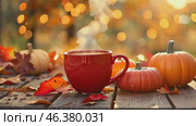 Steaming coffee cup on a autumn day blur bokeh background. Yellow leaves, red mug with warm smoke on an old wood table desk. Cozy fall season mood concept. Autumnal tea party atmosphere. Hot drink. Стоковое AI-видео, аниматор Марина Демидюк / Фотобанк Лори