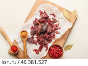 Board with spicy beef jerky on table. Стоковое фото, фотограф Pixel_shot / Фотобанк Лори
