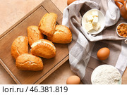 Wooden board of tasty sochniki with cottage cheese on beige background. Стоковое фото, фотограф Pixel_shot / Фотобанк Лори