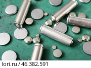 Different batteries on green background, closeup. Стоковое фото, фотограф Pixel_shot / Фотобанк Лори
