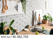 Pegboard with kitchenware on grey brick wall in modern kitchen. Стоковое фото, фотограф Pixel_shot / Фотобанк Лори
