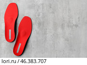Pair of red orthopedic insoles on grunge background. Стоковое фото, фотограф Pixel_shot / Фотобанк Лори