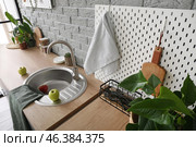 Wooden counter and pegboard with kitchen utensils near grey brick wall. Стоковое фото, фотограф Pixel_shot / Фотобанк Лори