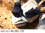 Male tourist making wooden stake in forest, closeup. Стоковое фото, фотограф Pixel_shot / Фотобанк Лори