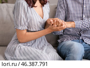 Young woman trying to make peace with husband after quarrel at home. Стоковое фото, фотограф Pixel_shot / Фотобанк Лори
