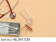 Stethoscope with gynecological speculum, pills and pap smear test tools on color background. Стоковое фото, фотограф Pixel_shot / Фотобанк Лори