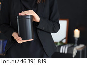 Grieving young woman with mortuary urn at funeral, closeup. Стоковое фото, фотограф Pixel_shot / Фотобанк Лори