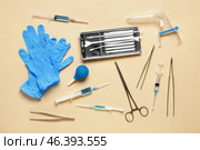 Medical gloves with gynecological speculum, pap smear test tools and syringes on beige background. Стоковое фото, фотограф Pixel_shot / Фотобанк Лори