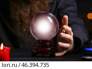 Male fortune teller with crystal ball at table, closeup. Стоковое фото, фотограф Pixel_shot / Фотобанк Лори