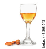 Glass of almond liquor and nuts on white background. Стоковое фото, фотограф Pixel_shot / Фотобанк Лори