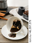 Cup with spent coffee grounds for fortune telling on table. Стоковое фото, фотограф Pixel_shot / Фотобанк Лори