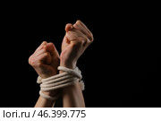 Female hostage with tied hands on dark background, closeup. Стоковое фото, фотограф Pixel_shot / Фотобанк Лори