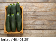 Wooden box with fresh zucchini squashes on wooden background. Стоковое фото, фотограф Pixel_shot / Фотобанк Лори