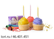 Tasty Birthday cupcakes, candles, gift and party whistles on white background. Стоковое фото, фотограф Pixel_shot / Фотобанк Лори