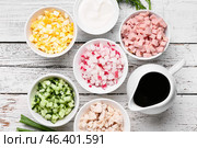 Bowls with different ingredients for okroshka and jug with kvass on light wooden background. Стоковое фото, фотограф Pixel_shot / Фотобанк Лори