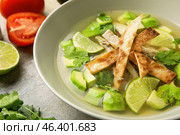 Plate of tasty Sopa de Lima soup on grey background, closeup. Стоковое фото, фотограф Pixel_shot / Фотобанк Лори