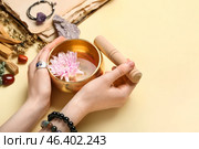 Hands with Tibetan singing bowl on color background. Стоковое фото, фотограф Pixel_shot / Фотобанк Лори