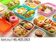 Many lunchboxes with different delicious food on white tile background. Стоковое фото, фотограф Pixel_shot / Фотобанк Лори