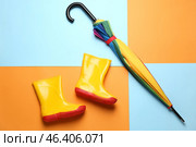 Stylish umbrella and gumboots on color background. Стоковое фото, фотограф Pixel_shot / Фотобанк Лори